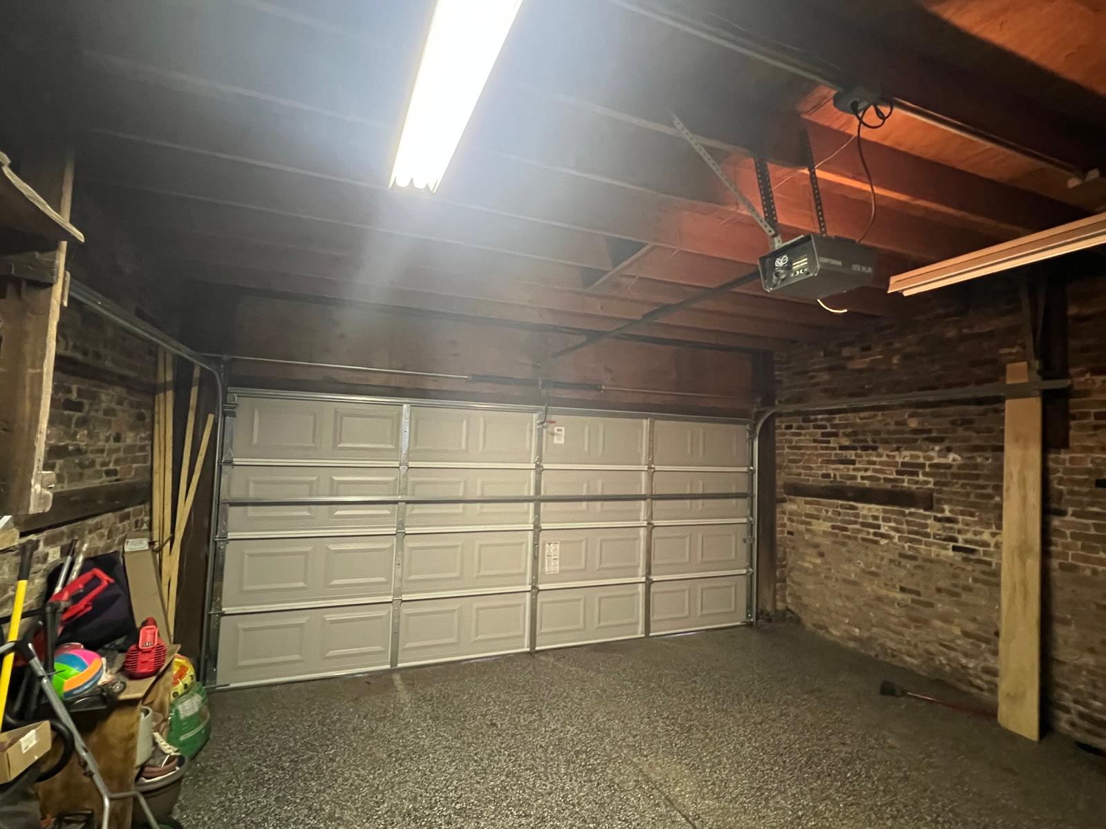 Wide interior view of the completed garage door and opener installation